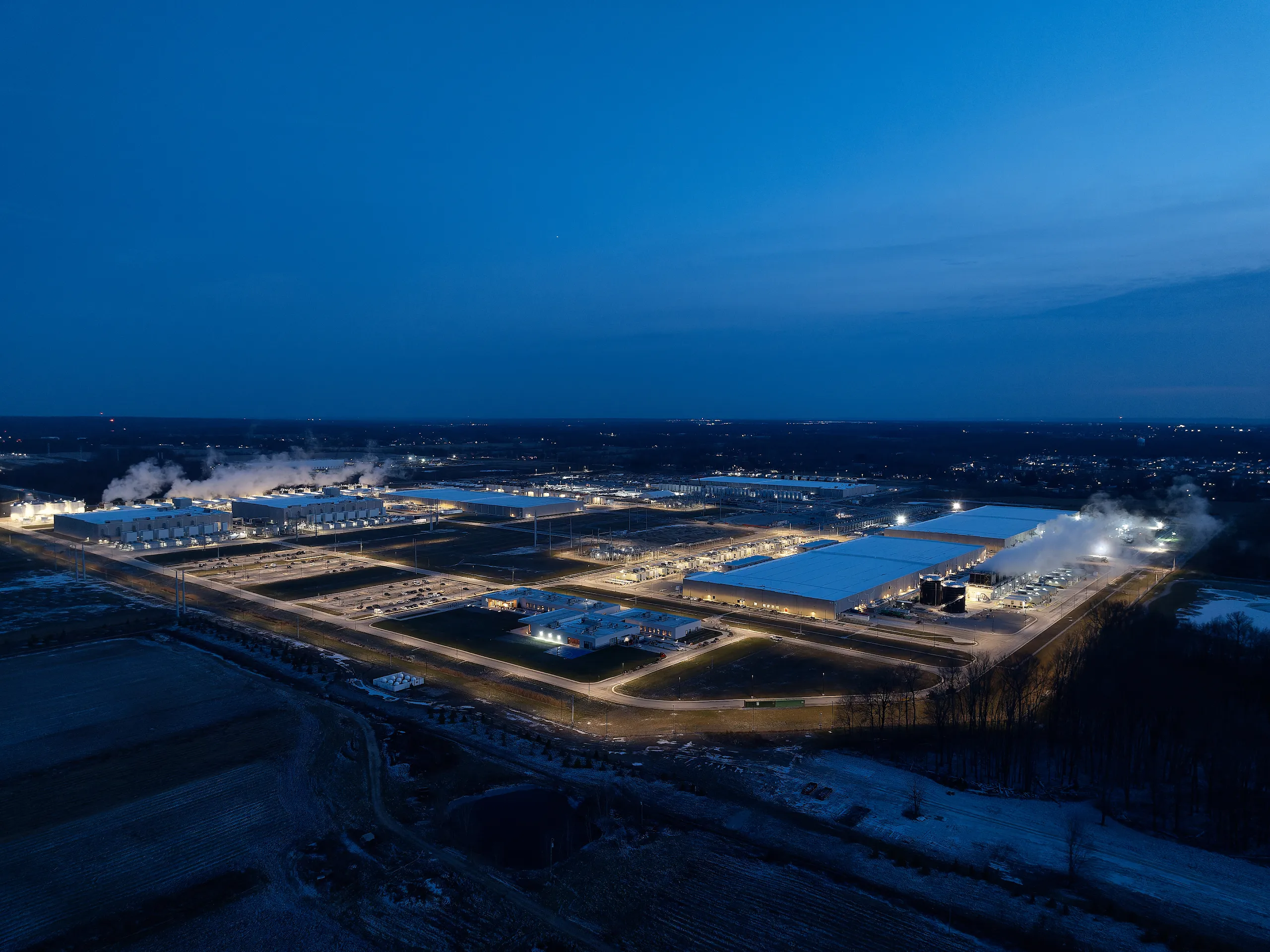 Enterprise data center campus illuminated at dusk